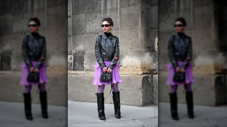 Woman in black leather and purple chiffon