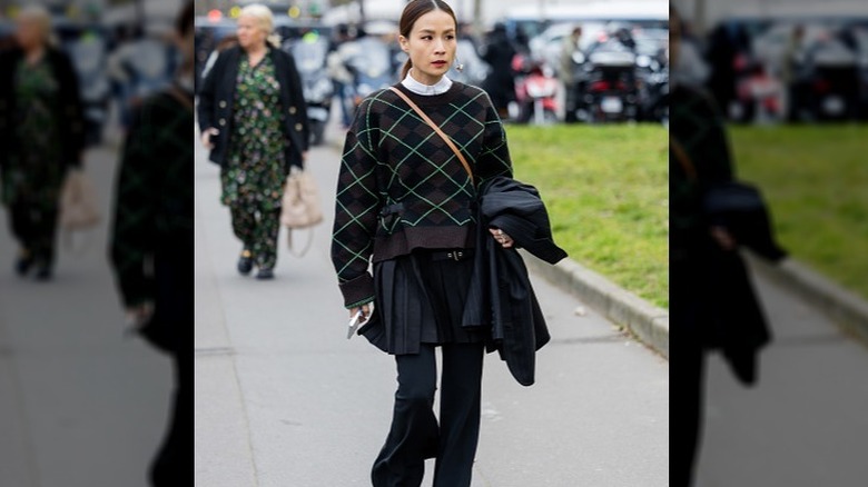 Woman in sweater, skirt, and pants