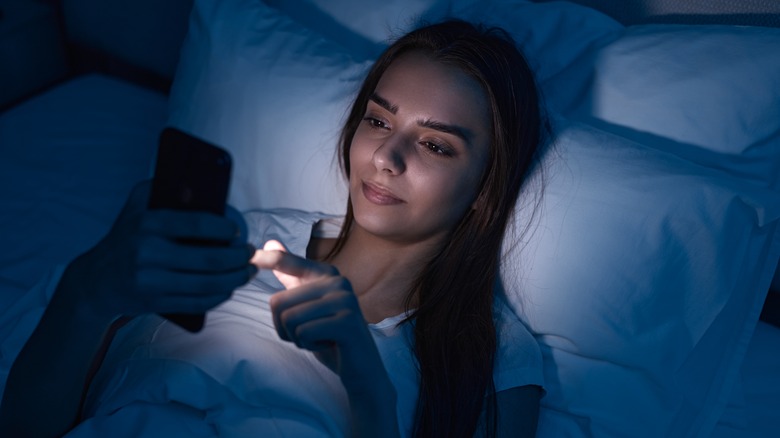 Girl on her phone in bed