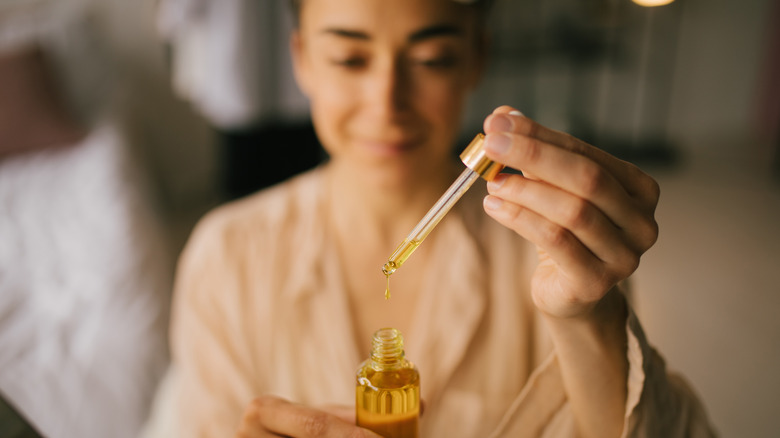 Woman using face oil before bed