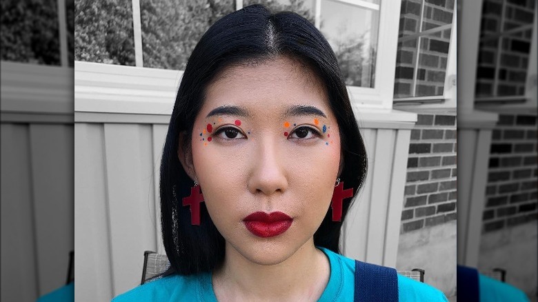 Woman models colored polka dot graphic eyeliner