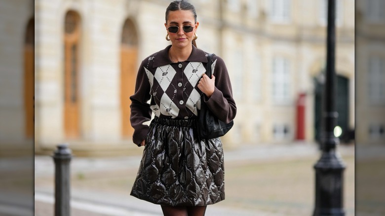 woman wearing brown argyle polo top