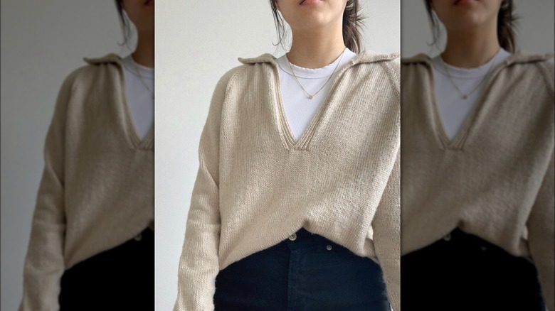 girl wearing a beige polo sweater