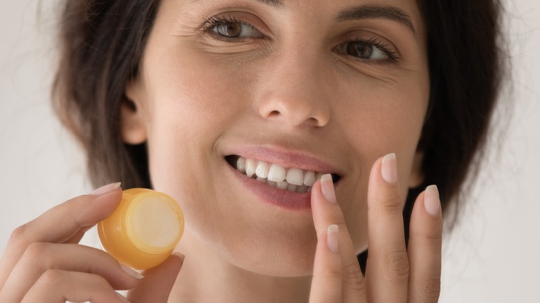 woman use lip balm