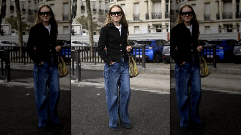 Woman wearing blazer, pooling jeans