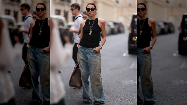 Woman wearing tank, baggy jeans