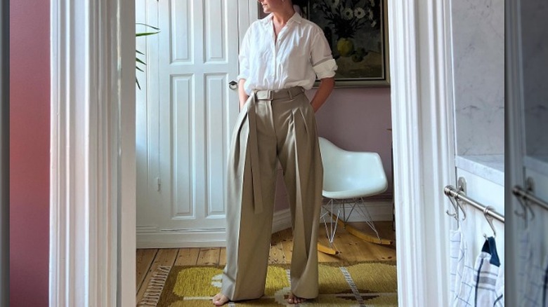 woman wearing a poplin white button up and khaki trousers