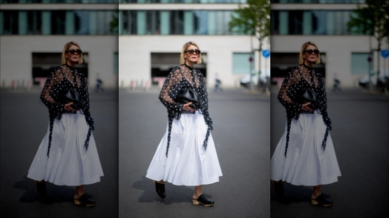 woman a black blouse and white poplin cotton skirt