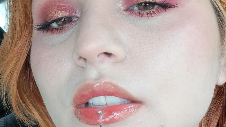 Girl wearing coral lip balm