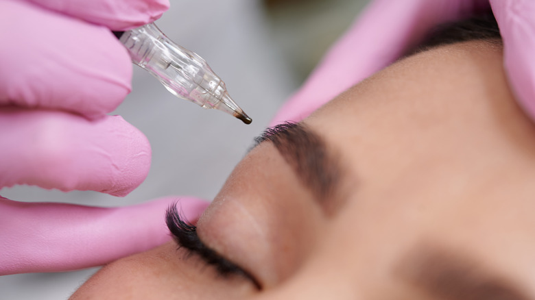 woman getting powdered eyebrows 