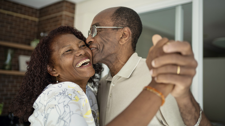 Older couple kissing and dancing