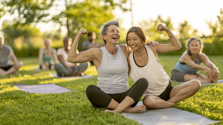 People laughing while doing yoga outside