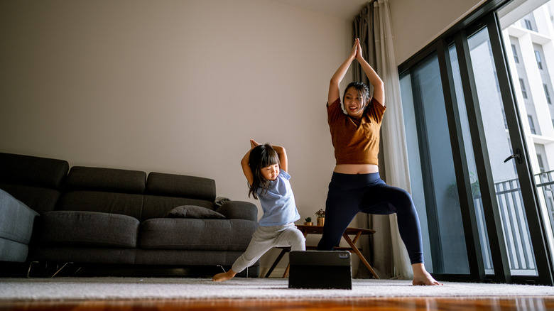 Woman and young girl doing yoga poses