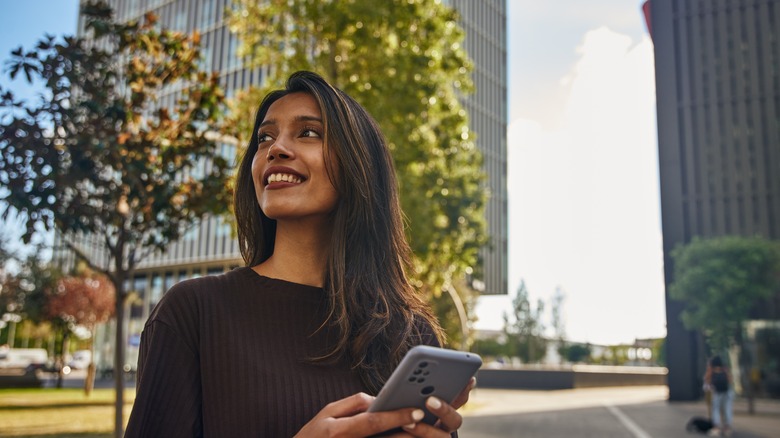 Woman standing outside with phone