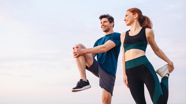 Couple stretching before a run