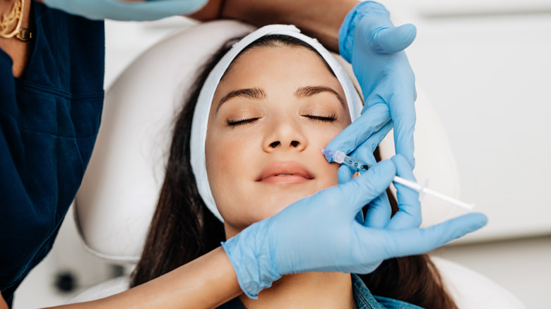 woman getting facial injection