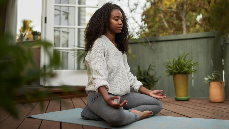 woman meditating at home