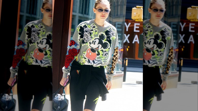 Gigi Hadid in crewneck sweatshirt and biker shorts