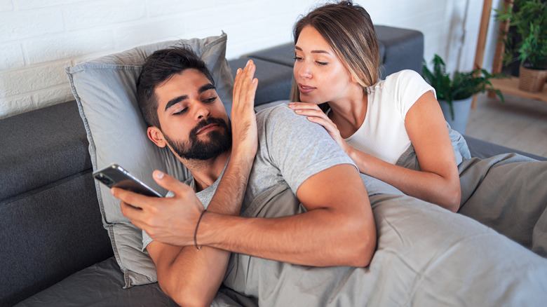 Man preventing partner from looking at phone