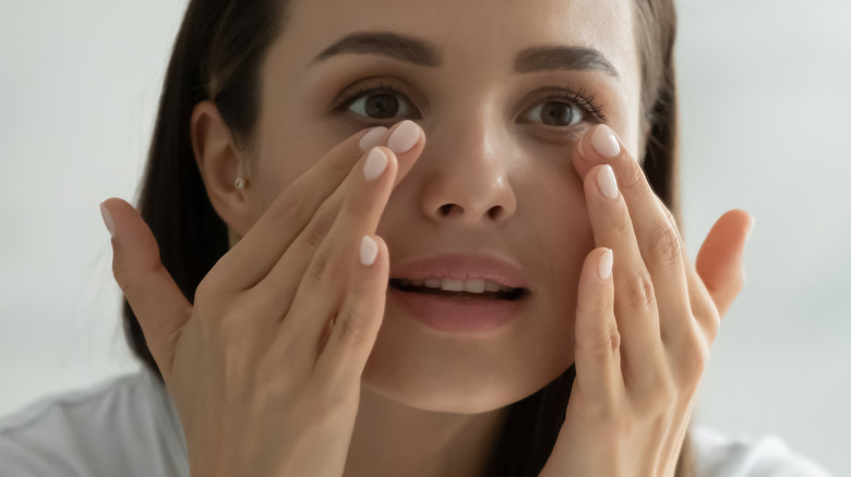 woman massaging face