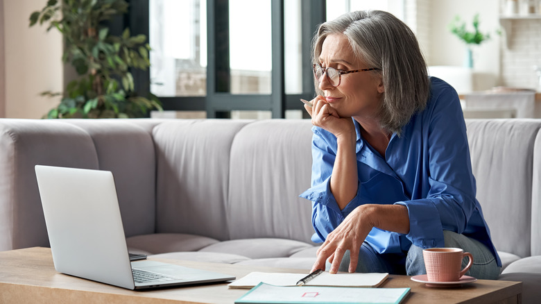 Woman working on couch