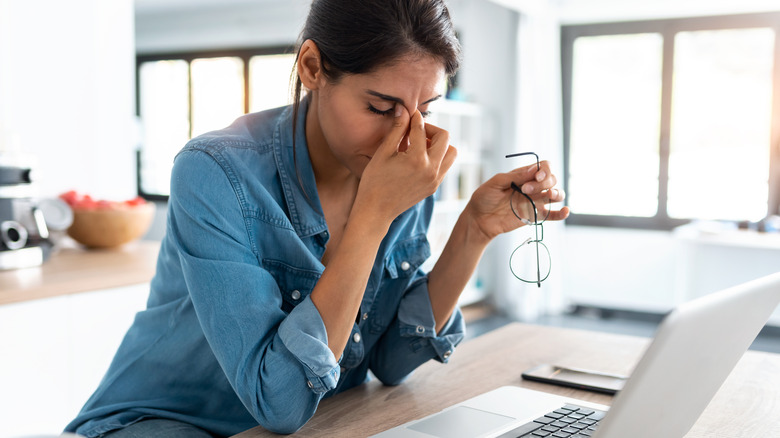 Stressed woman working on laptop