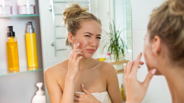 Woman face rash in mirror