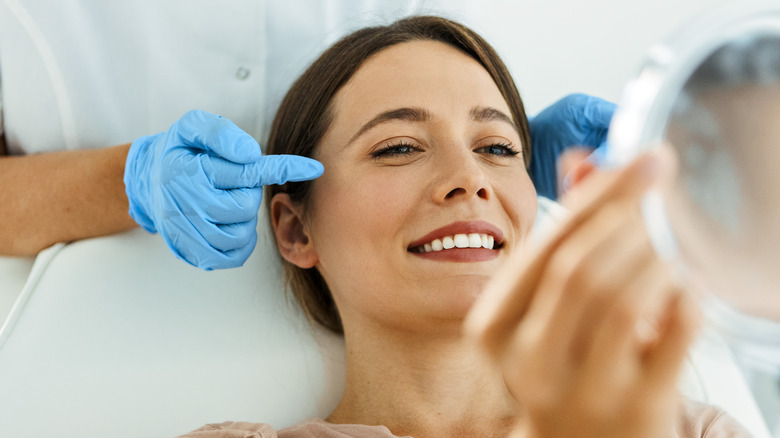 Woman smiling doctor's office mirror