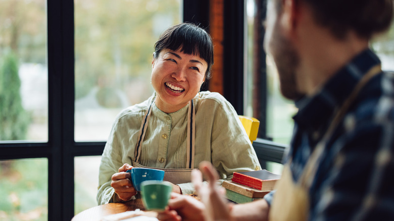 A woman having coffee with a man