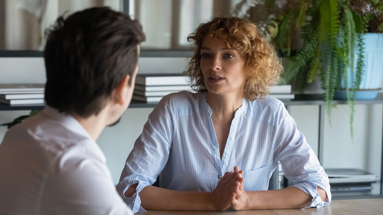 Woman talking to a man in office