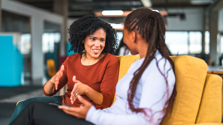 Women sitting on sofa talking