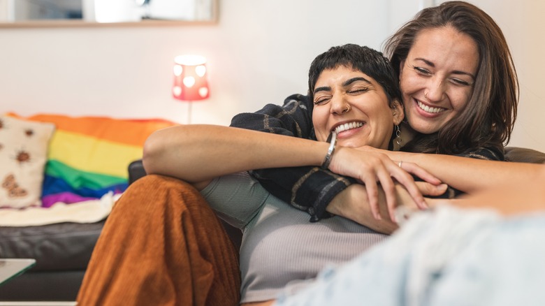 LGBTQ+ couple laughing at home