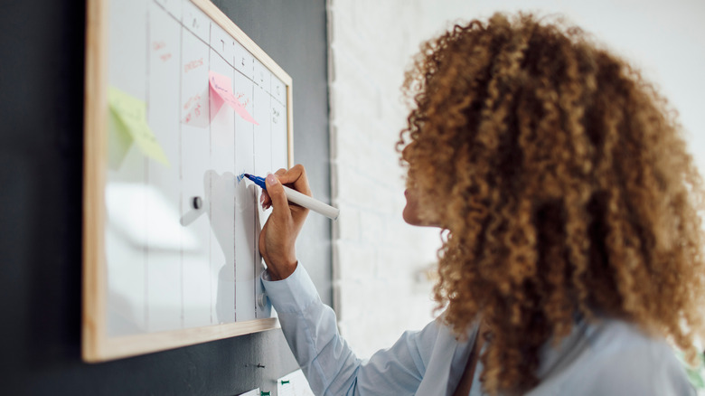 Woman marking off days on her calendar