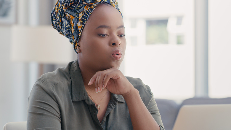 Business woman exhaling through mouth