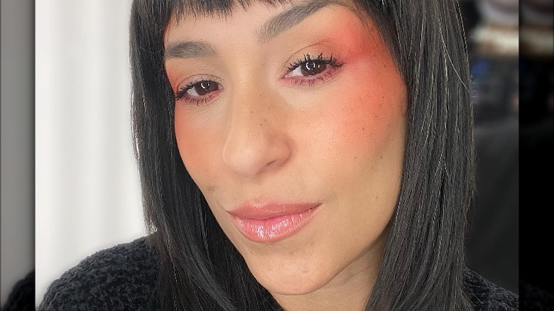 Woman with freckles and orange blush