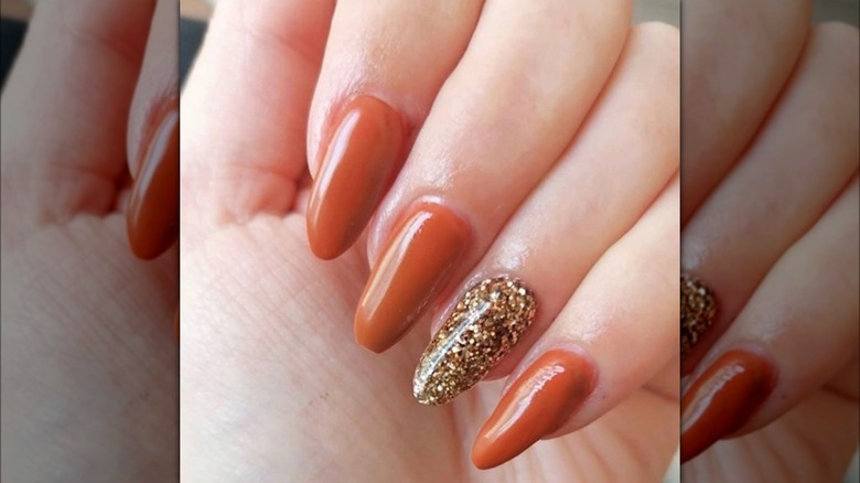 orange and gold glitter nails