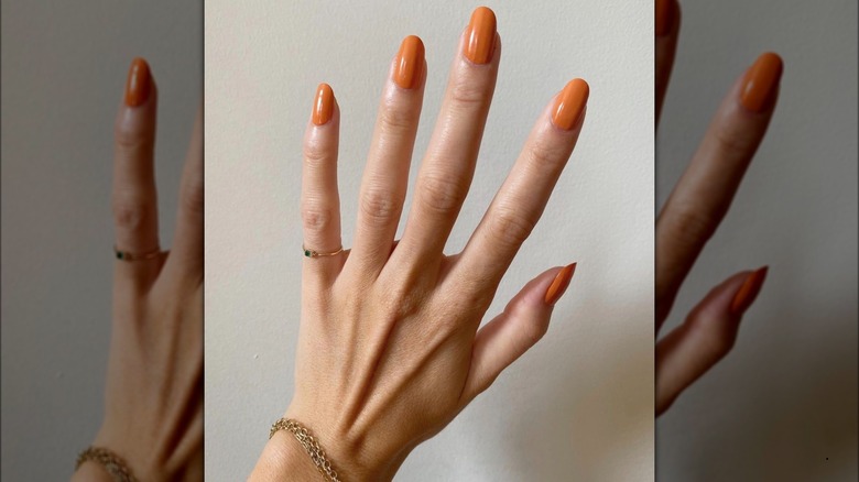 Orange mani and gold jewelry