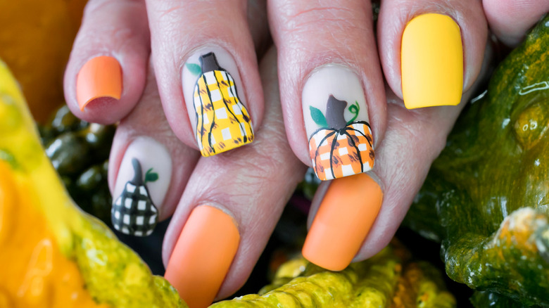 Pumpkin nail design with plaid pattern