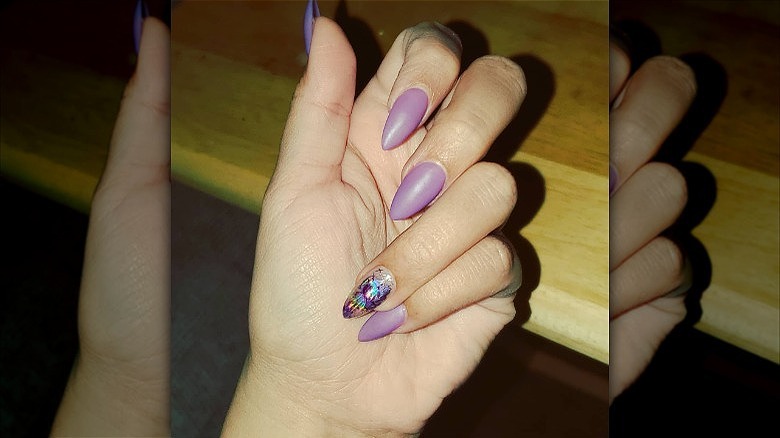 woman's hand matte purple manicure