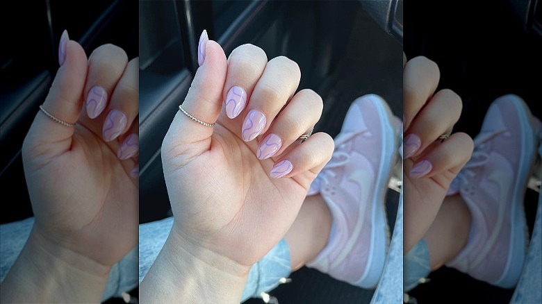 woman's hand purple squiggle manicure