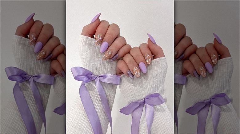 woman's hands purple flowers manicure