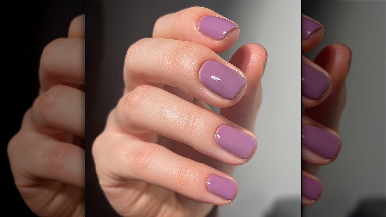 woman's hand with mauve manicure