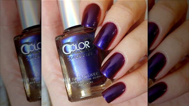 woman's hand oil slick purple manicure