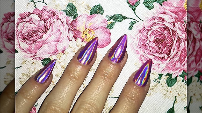 hand with purple chrome manicure