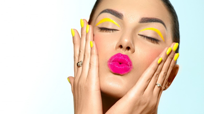 Woman wearing bright pink lipstick