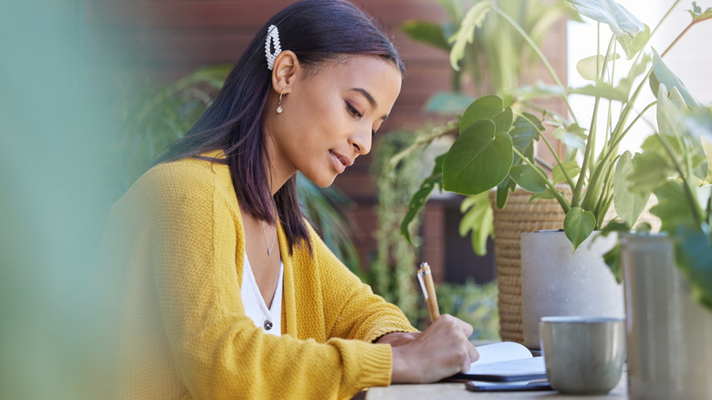 girl writing in her journal 