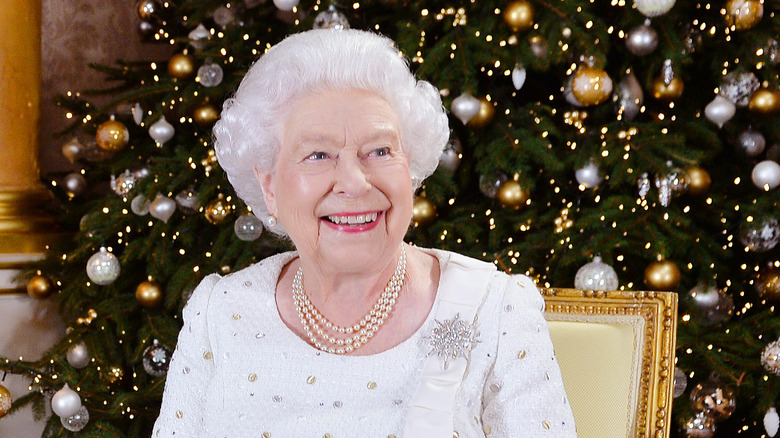 Queen Elizabeth seated in front of Christmas tree during annual speech
