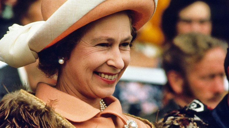 Queen Elizabeth wearing peach colored outfit