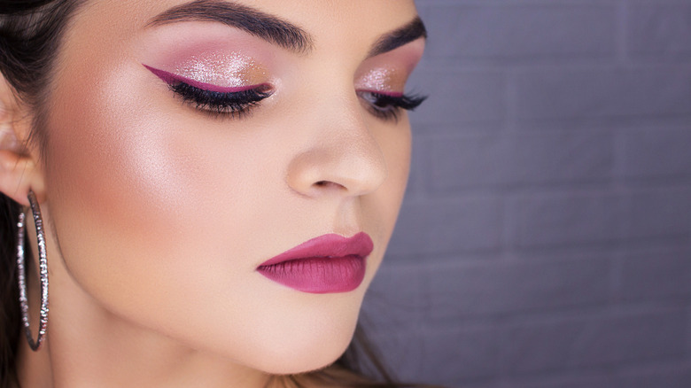 Woman wearing purple winged eyeliner