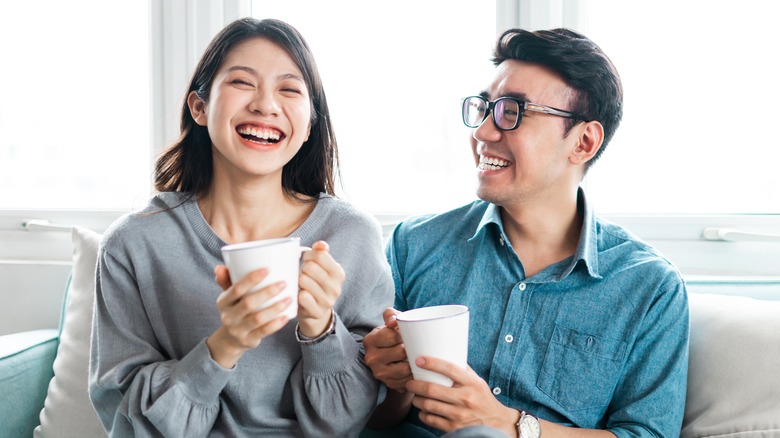 couple smiling on sofa